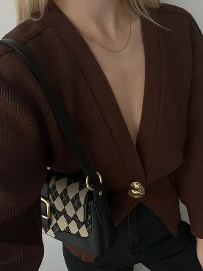 Trendy fall cardigan for women featuring deep V-neckline, puff sleeves, and cinched waist quiet luxury knitwear for effortless autumn outfits, workwear layering, and coffee-date style.