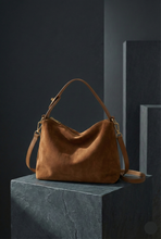 Load image into Gallery viewer, brown suede shoulder bag, women’s suede handbag, Soft suede shoulder bag for women with slouchy hobo silhouette, zip closure, and minimalist design, ideal as an everyday work bag, fall handbag, and quiet luxury accessory, slouchy hobo bag.