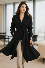Load image into Gallery viewer, Oversized trench coat women, double breasted belted black trench, old money belted trench, classic street style black trench, Pinterest trending black trench fall outfit, belted oversized trench, work-appropriate black trench women, Instagram worthy chic fall outfit.