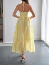 Load image into Gallery viewer, Backless halterneck maxi dress with tiered ruffles flowing in the breeze – perfect for a romantic summer beach days, or summer date nights getaway.