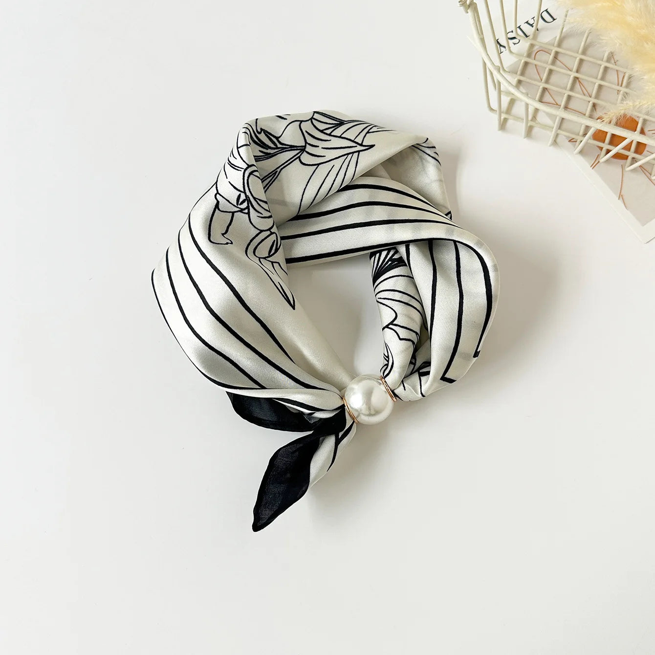 Printed faux silk neck scarf with a magnetic pearl fastening, perfect for women looking for an easy-to-wear scarf necklace to pair with blazers, shirts, and knitwear.