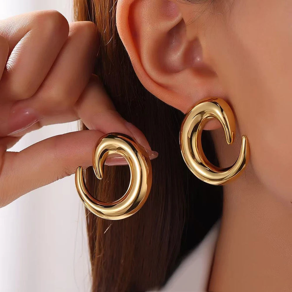 Chunky gold hoop earrings, statement hoop earrings, sculptural hoop earrings,  high-polish metallic finish stainless steel with sculptural open hoop design, bold curved silhouette, chunky gold hoop earrings for women everyday styling, perfect for minimalist fashion outfits.