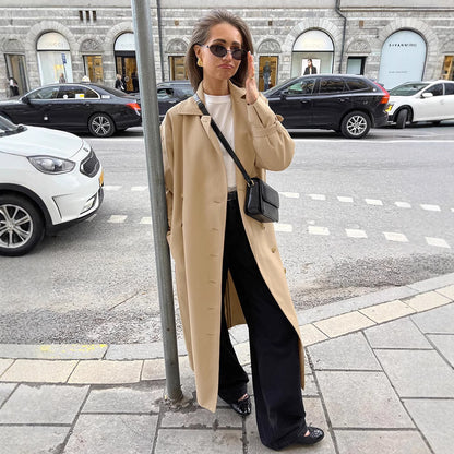 Double breasted trench coat women in warm beige with belted cuffs, classic city double breasted trench coat women aesthetic for smart casual trench coat outfit and fall layering outfits, classic beige trench coat outfit, belted trench coat for work women.