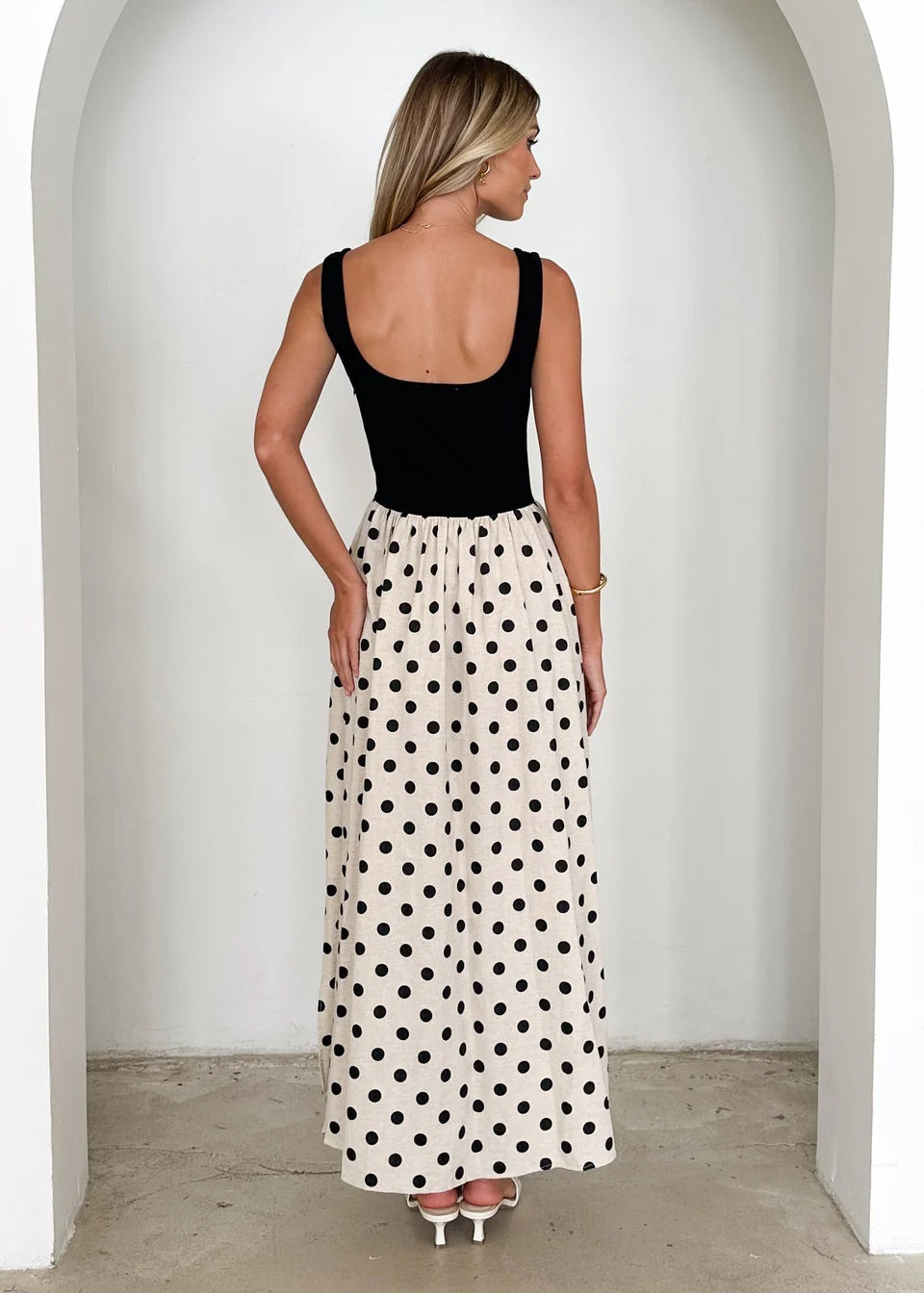 Contrast waist maxi dress with square neck polka dot maxi dress design, fitted black bodice maxi skirt and cream polka dot summer dress flow, ideal fall wedding guest polka dot dress look.