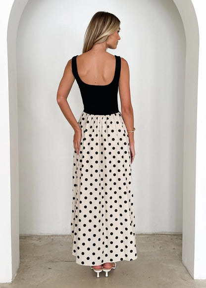 Contrast waist maxi dress with square neck polka dot maxi dress design, fitted black bodice maxi skirt and cream polka dot summer dress flow, ideal fall wedding guest polka dot dress look.