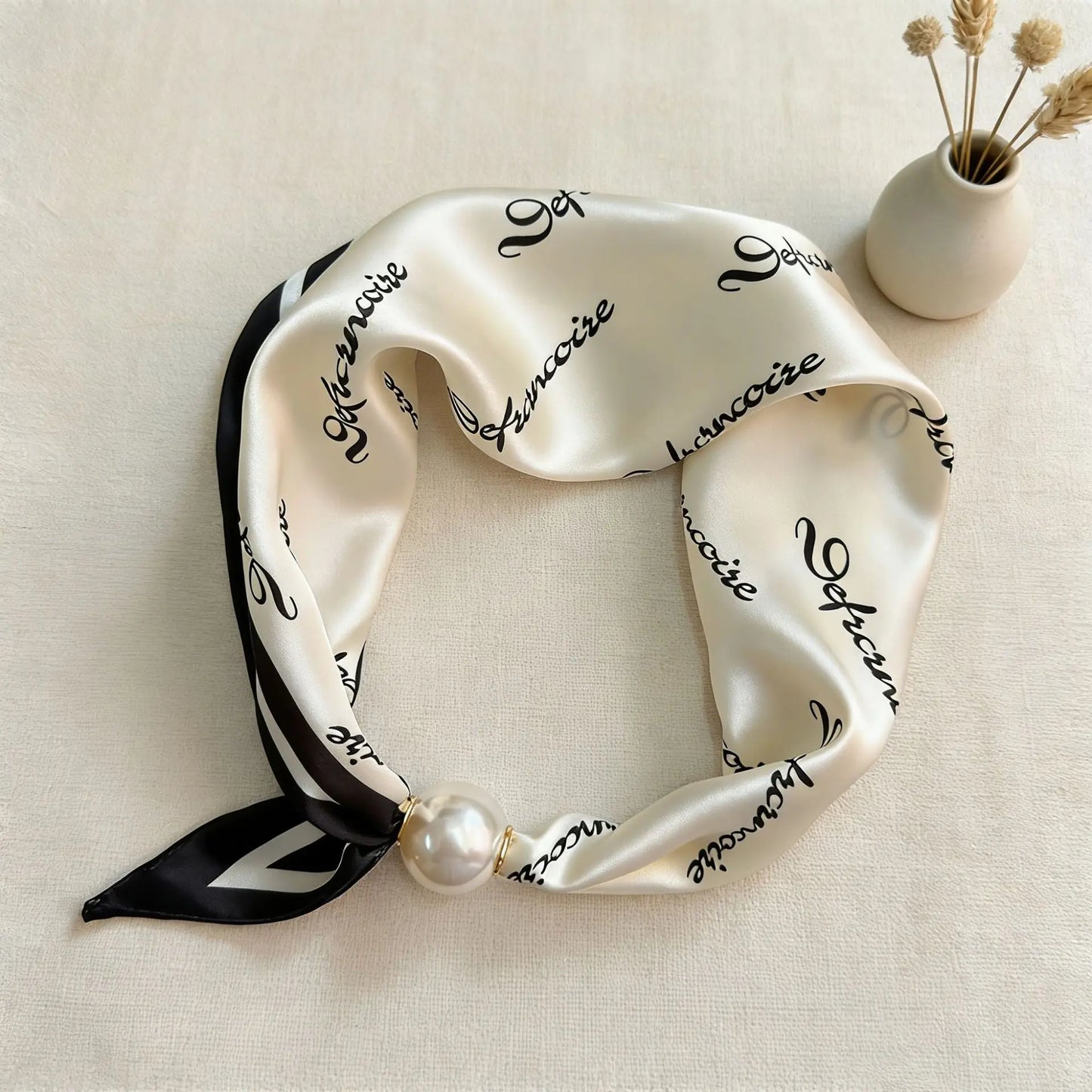 Printed faux silk neck scarf with a magnetic pearl fastening, perfect for women looking for an easy-to-wear scarf necklace to pair with blazers, shirts, and knitwear.