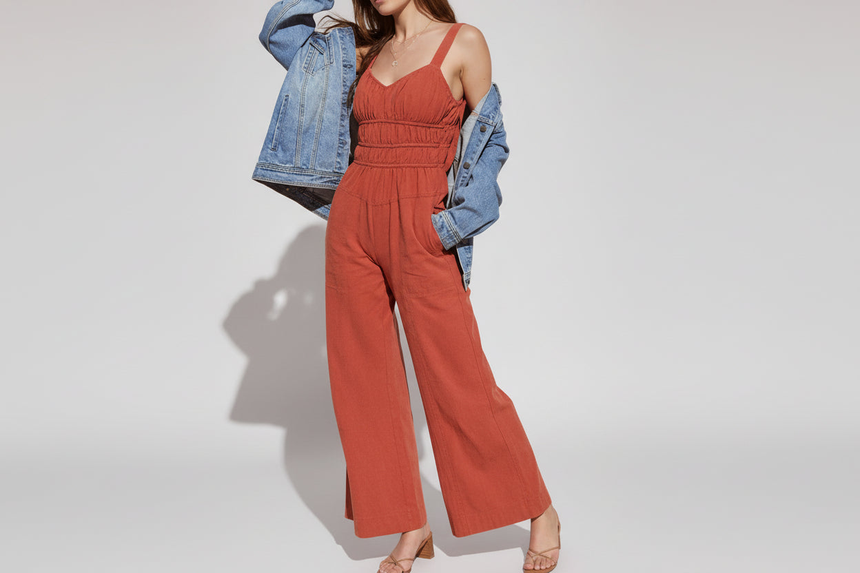rust smocked waist jumpsuit, vacation V-neck smocked jumpsuit, earth tone jumpsuit, quiet luxury jumpsuit, Open back tie smocked jumpsuit, Smocked waistband jumpsuit, Vacation wide leg jumpsuit, summer brunch jumpsuit, warm weather flowy jumpsuit.