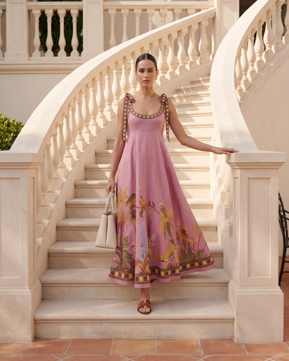 Square neckline maxi dress featuring an empire waist maxi dress silhouette, oversized self-tie shoulder bows and ornamental border hem, perfect as a garden party maxi dress with bohemian luxury appeal.