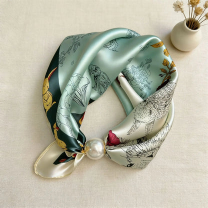 Women's magnetic neck scarf in a printed faux silk fabric with an elegant pearl closure, creating a stylish no-tie fashion accessory for everyday wear and gifting.