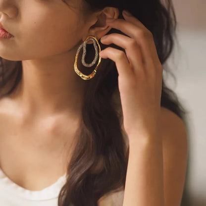 gold and stone earrings, fancy jewelery, statement jewelry,Gold sculptural pavé crystal double-oval earrings, hypoallergenic and nickel-free, elegant statement drop earrings for women, U.S. jewelry fashion accessory.