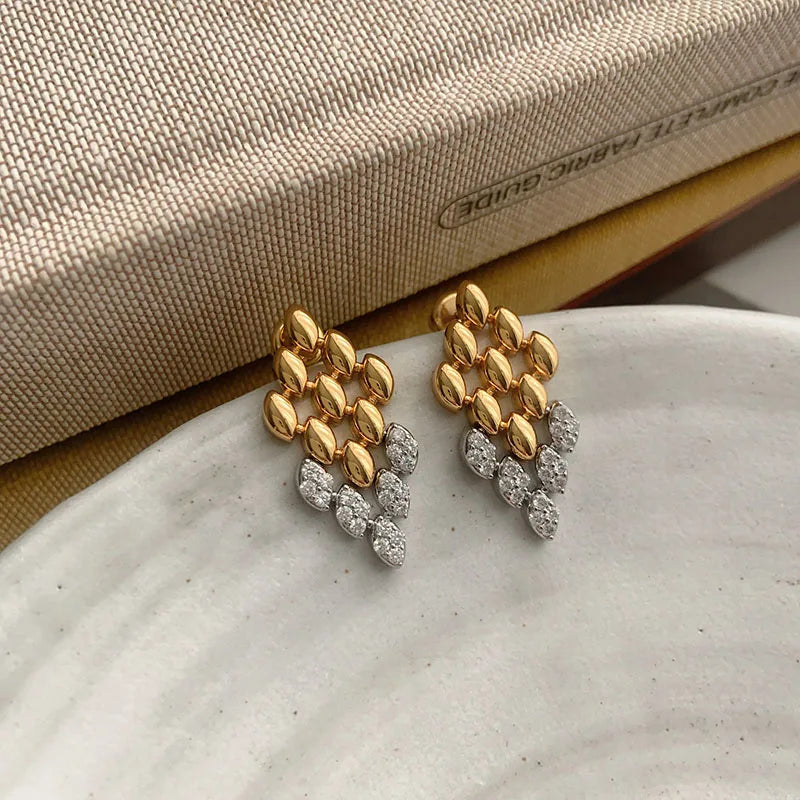 gold drop earrings, Modern gold drop earrings featuring a rhombus geometric silhouette with subtle crystal accents, modern gold earrings, crystal drop earrings, Chic statement earrings for women styled for office wear, cocktail events, evening looks, and special occasions.