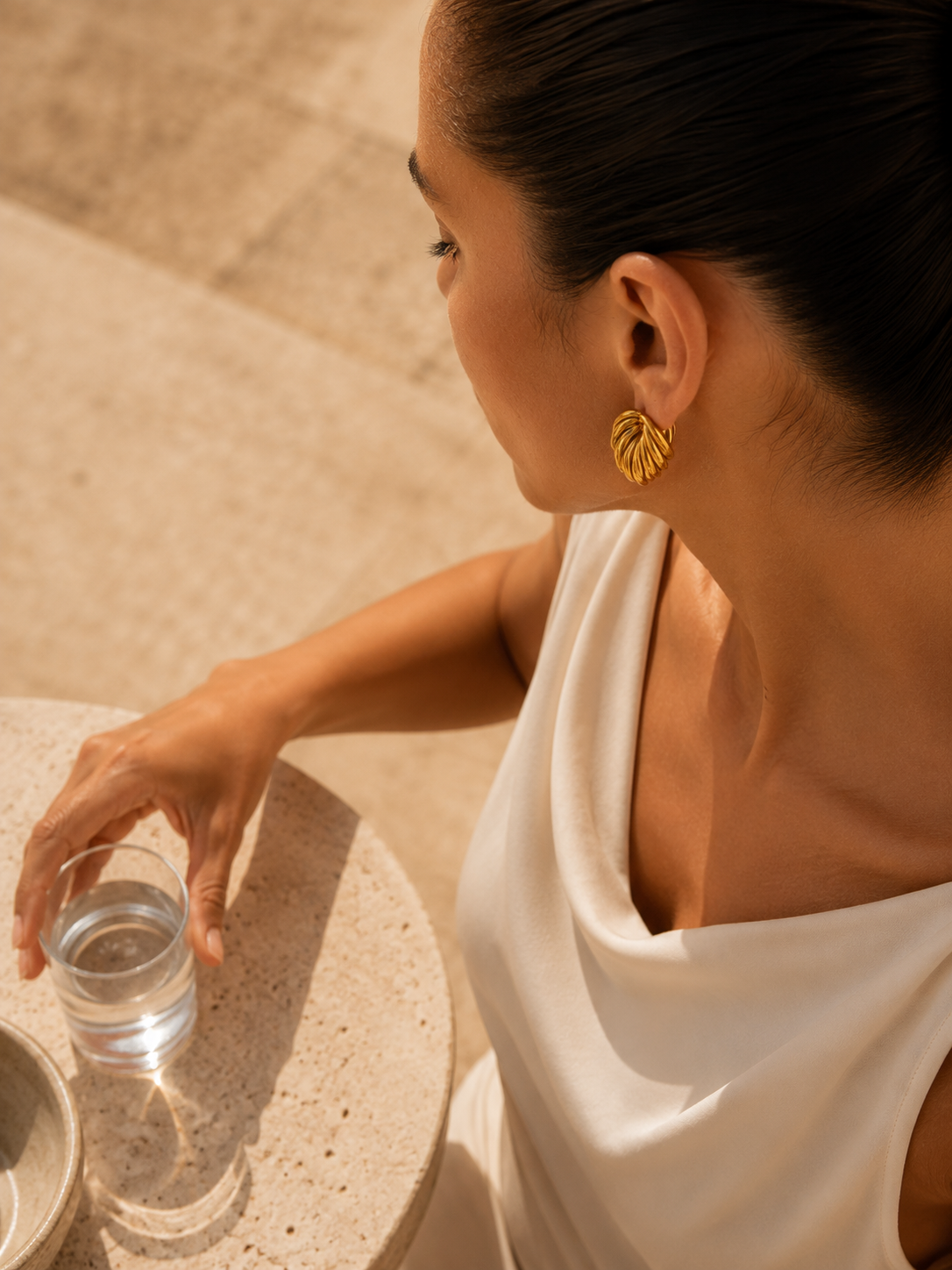 Sculptural gold knot statement stud earrings featuring a chunky intertwined silhouette for everyday and occasion wear.
