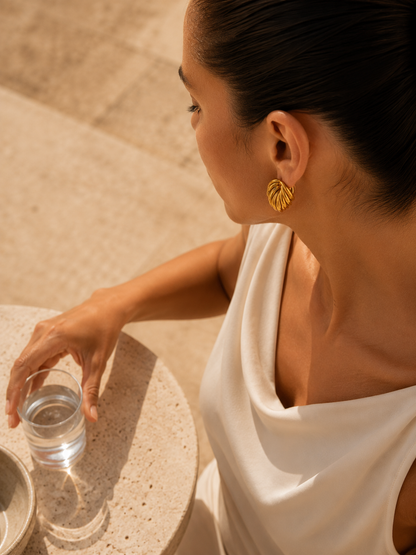 Sculptural gold knot statement stud earrings featuring a chunky intertwined silhouette for everyday and occasion wear.