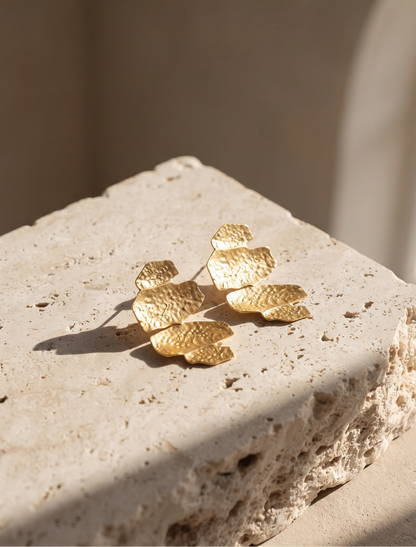 Modern sculptural hammered gold drop earrings featuring an irregular abstract silhouette and richly textured finish, ideal for statement jewellery lovers seeking versatile gold accessories for work, parties and vacation outfits.