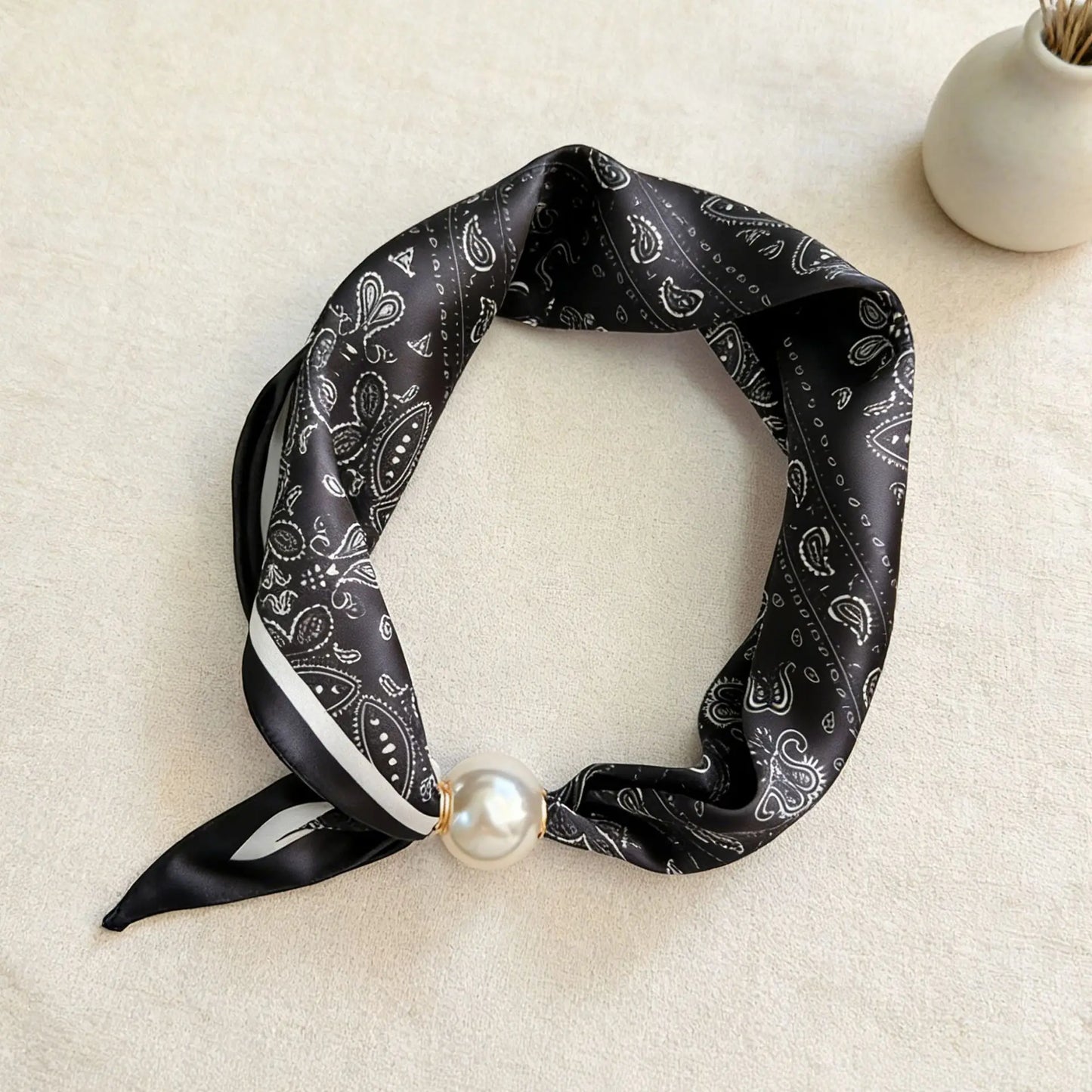 Women's silk-feel printed scarf with an integrated magnetic pearl closure, offering the polished look of a tied neck scarf without the effort for office and business casual styling.
