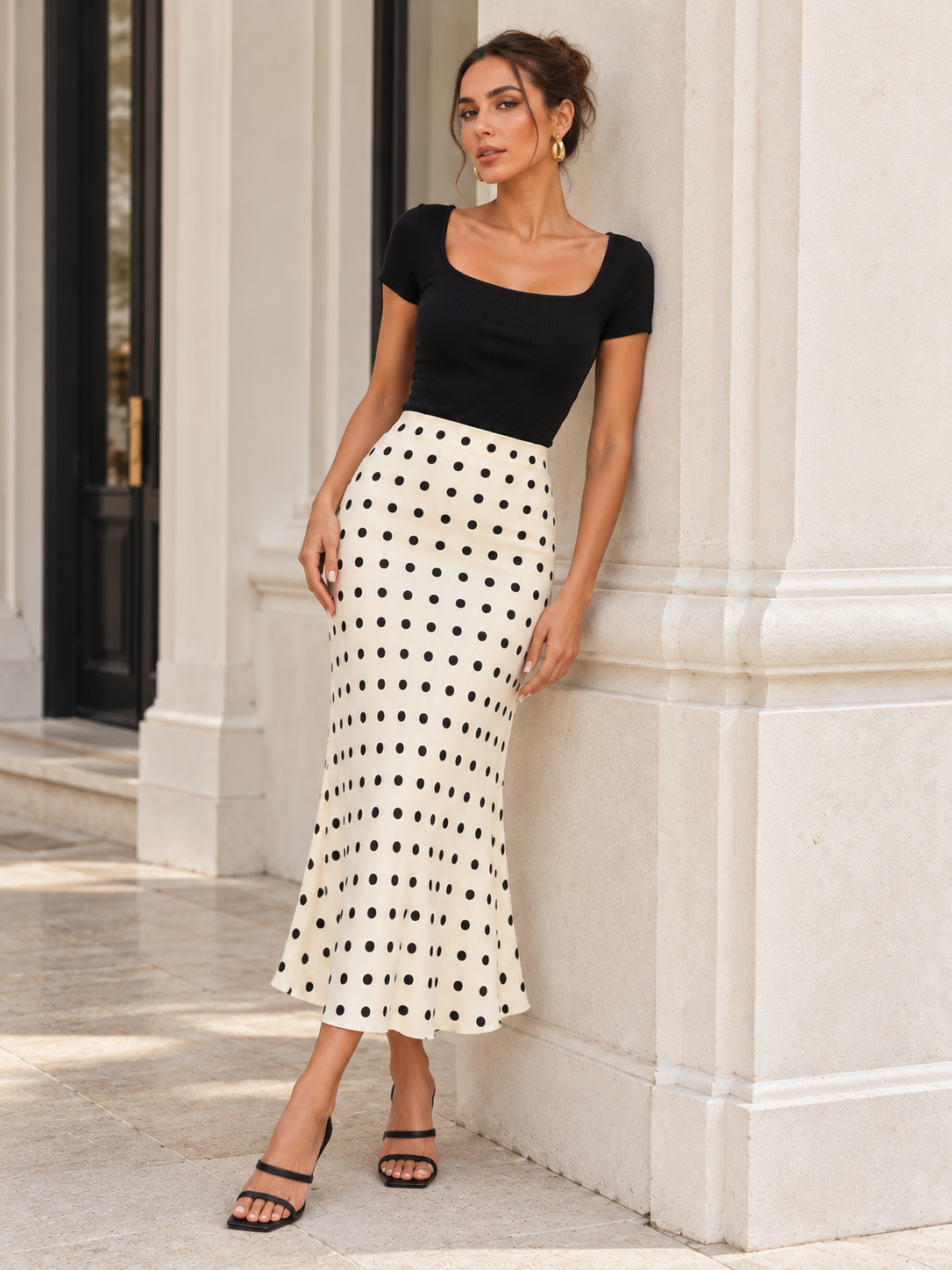 White polka dot fishtail midi skirt with a fitted waist and softly flared hem, styled as a romantic feminine skirt for a quiet luxury summer outfit with refined Parisian-inspired appeal. Polka dot flared midi skirt designed for brunch and weekend outfits with fitted tops, ballet flats, structured bags and understated accessories.
