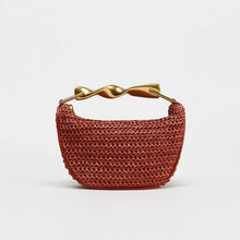 Load image into Gallery viewer, Crossbody woven bag, sculptural handle purse, terracotta shoulder bag for evening soiree handbag, lightweight designer look tote, straw sling bag, woven sling bag, bucket sling bag, crossbody straw sling bag, raffia sling bag, chic woven sling purse.