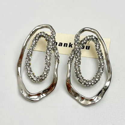 Women’s statement drop earrings in gold and silver with pavé crystals, sculptural modern design, lightweight and nickel-free, perfect jewelry for U.S. shoppers.