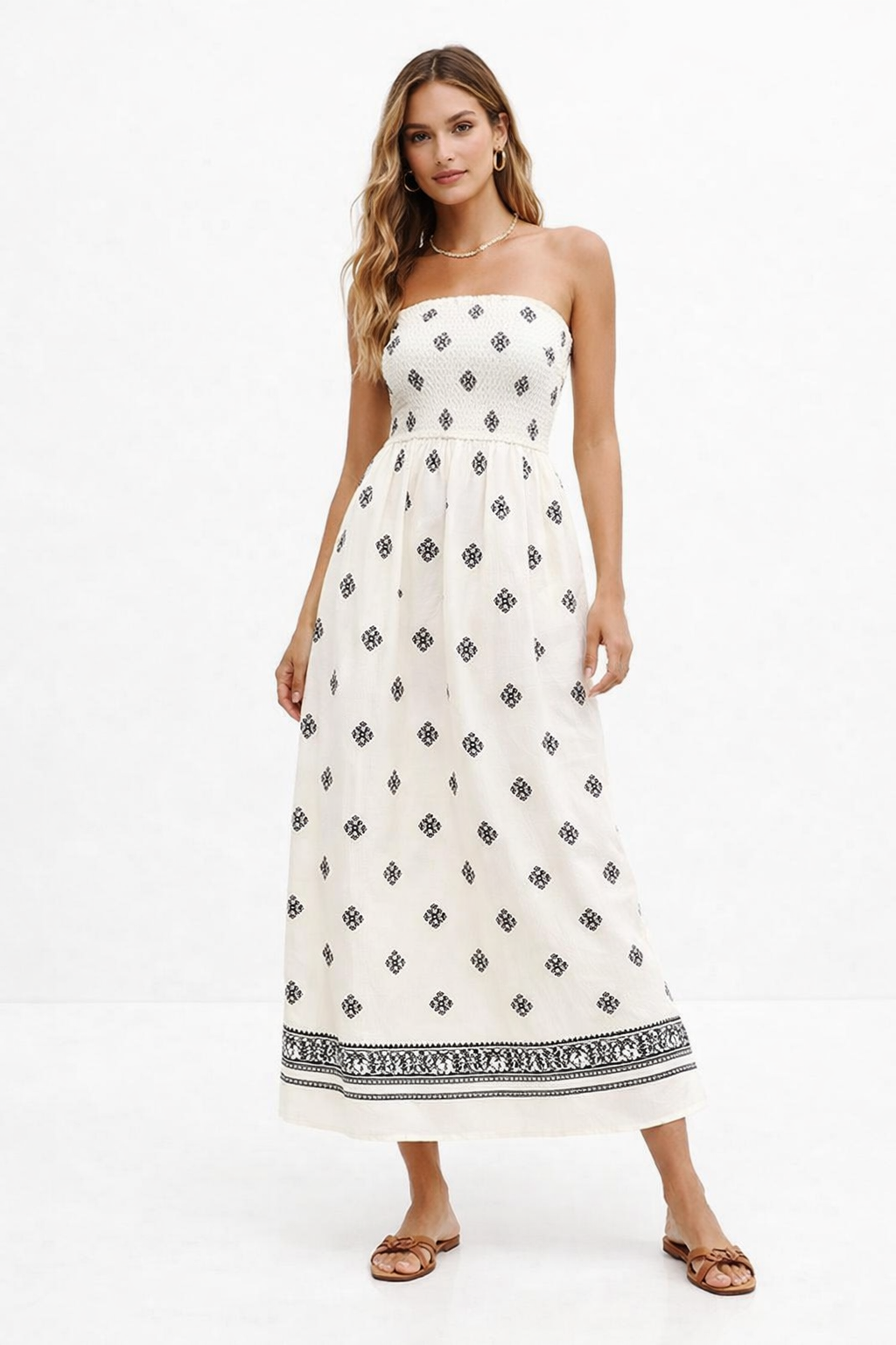 Cream smocked strapless printed midi vacation dress, geometric print A-line midi resort, Strapless smocked bodice midi, 2026 geometric print midi dress,  Breezy Cream Black Geometric Print Smocked Strapless Midi Dress. Elastic smocked bodice, A-line skirt, geometric border print.