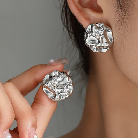 statement stud earrings for women, minimalist statement earrings, Abstract statement stud earrings in silver with a textured hammered surface, bold architectural jewelry style ideal for workwear, parties, and minimalist fashion wardrobes.