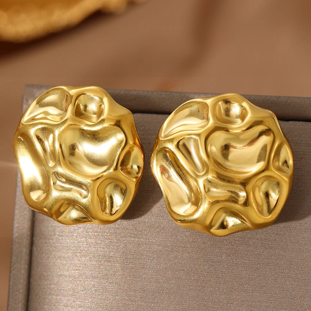 statement stud earrings, gold stud earrings, textured gold earrings, Sculptural gold statement stud earrings with an abstract textured metal finish, chunky modern design, bold fashion jewelry for women, perfect for workwear, evening outfits, and minimalist luxury looks.