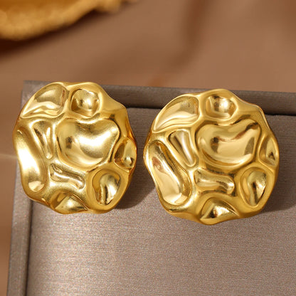 statement stud earrings, gold stud earrings, textured gold earrings, Sculptural gold statement stud earrings with an abstract textured metal finish, chunky modern design, bold fashion jewelry for women, perfect for workwear, evening outfits, and minimalist luxury looks.