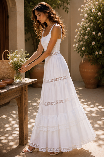 White tiered ruffle maxi dress with a square neckline, lace shoulder straps, tiered maxi skirt, hidden walking slit, and delicate lace detailing, styled as a beach wedding dress for coastal ceremonies, resort vacations, and romantic summer occasions.