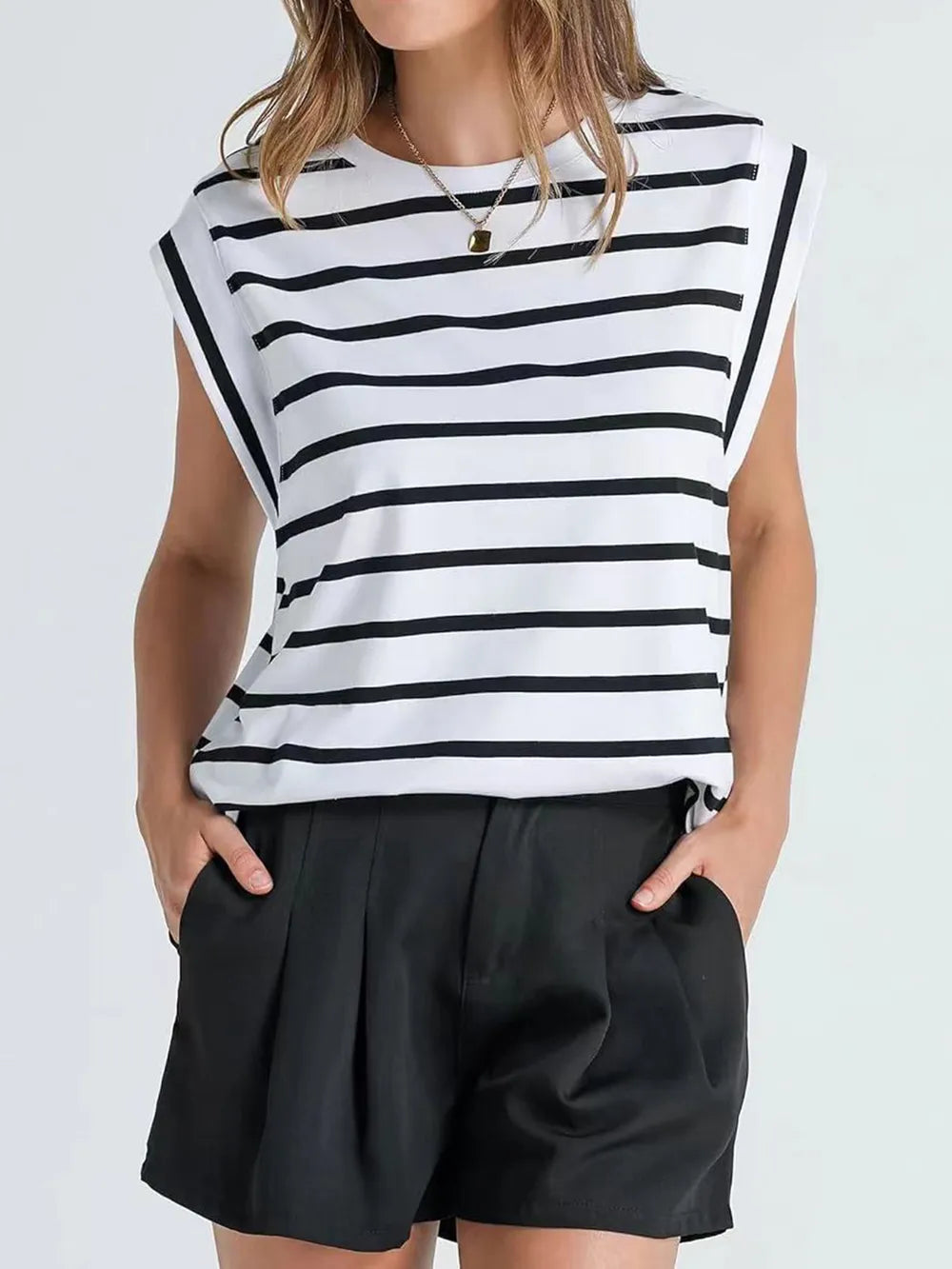 boat neckline striped top, casual workwear summer top, expensive looking basics women, capsule wardrobe essentials women, Women’s striped summer blouse in soft draped fabric with cap sleeve detailing, quiet luxury casual top for travel capsule wardrobes and hot weather everyday outfits, flattering tops for broad shoulders.