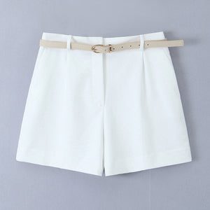 white tailored shorts, shorts with belt, belted shorts, office shorts, ladies tailored shorts, High-waisted wide-leg belted shorts for women, tailored high-waist pleated design, high-waist belted shorts, chic neutral outfit for summer travel, office wear, and effortless brunch styling.