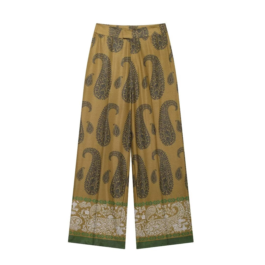 Paisley print pants paired with silk shirt set creating satin paisley print coord set silhouette, wide leg pants women styling for vacation coord sets, business casual set dressing and elegant matching set outfits.