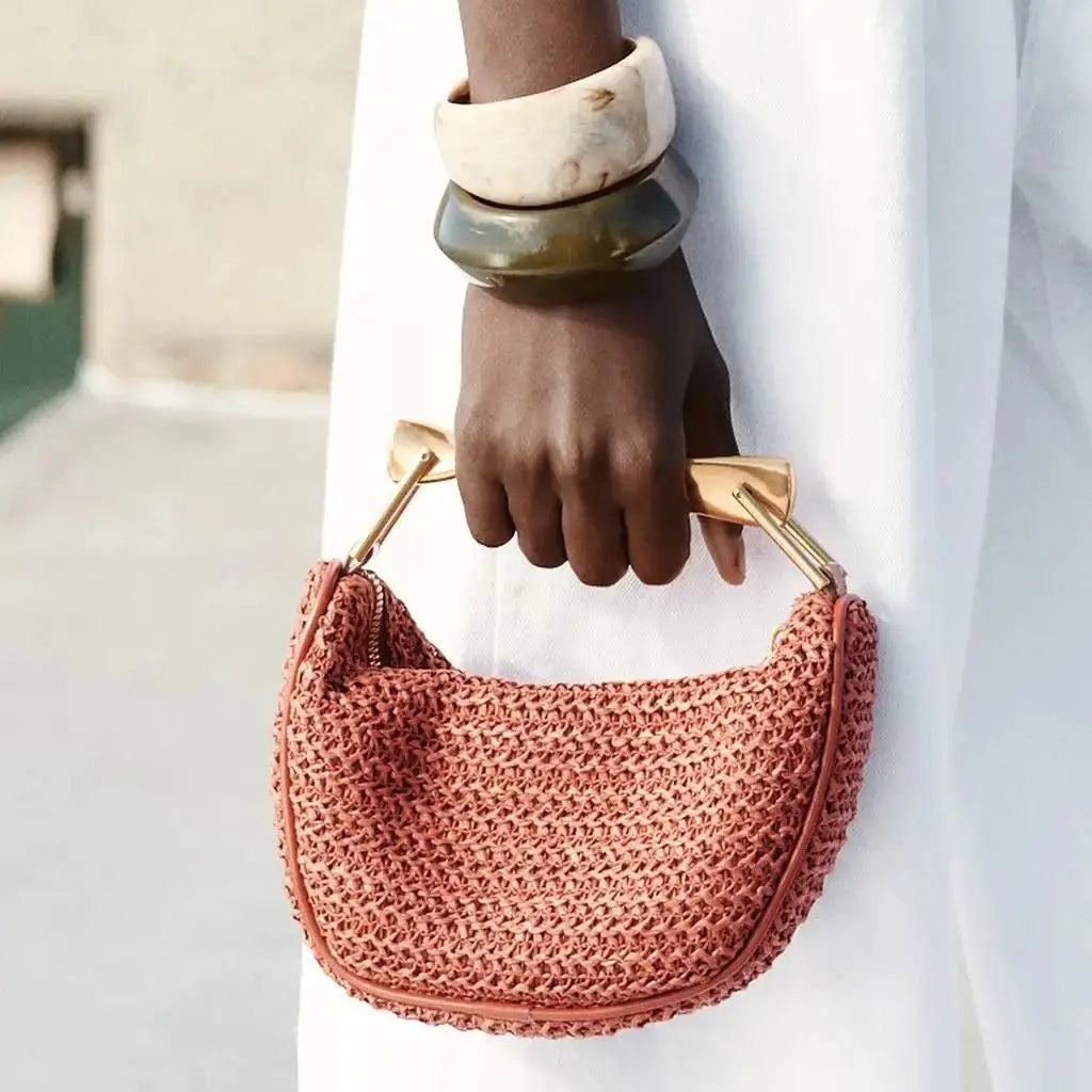 woven straw bucket bag, Sculpted handle bag for working moms, terracotta shoulder bag, work-appropriate summer tote bag, compact woven bag for essentials.