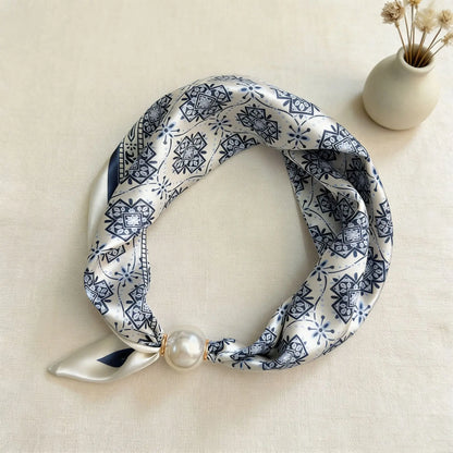 Printed faux silk scarf with a magnetic pearl fastening, perfect for travel wardrobes, European vacations, weekend brunches, and lightweight resort-inspired accessorizing.