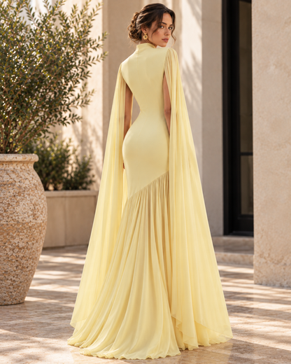 Asymmetrical Draped cape sleeve gown, Women’s yellow high neck evening gown with cape sleeves, fitted waist and flowing floor-length skirt, featuring an asymmetrical pleated drape for a sophisticated formal dress suitable for weddings and galas.